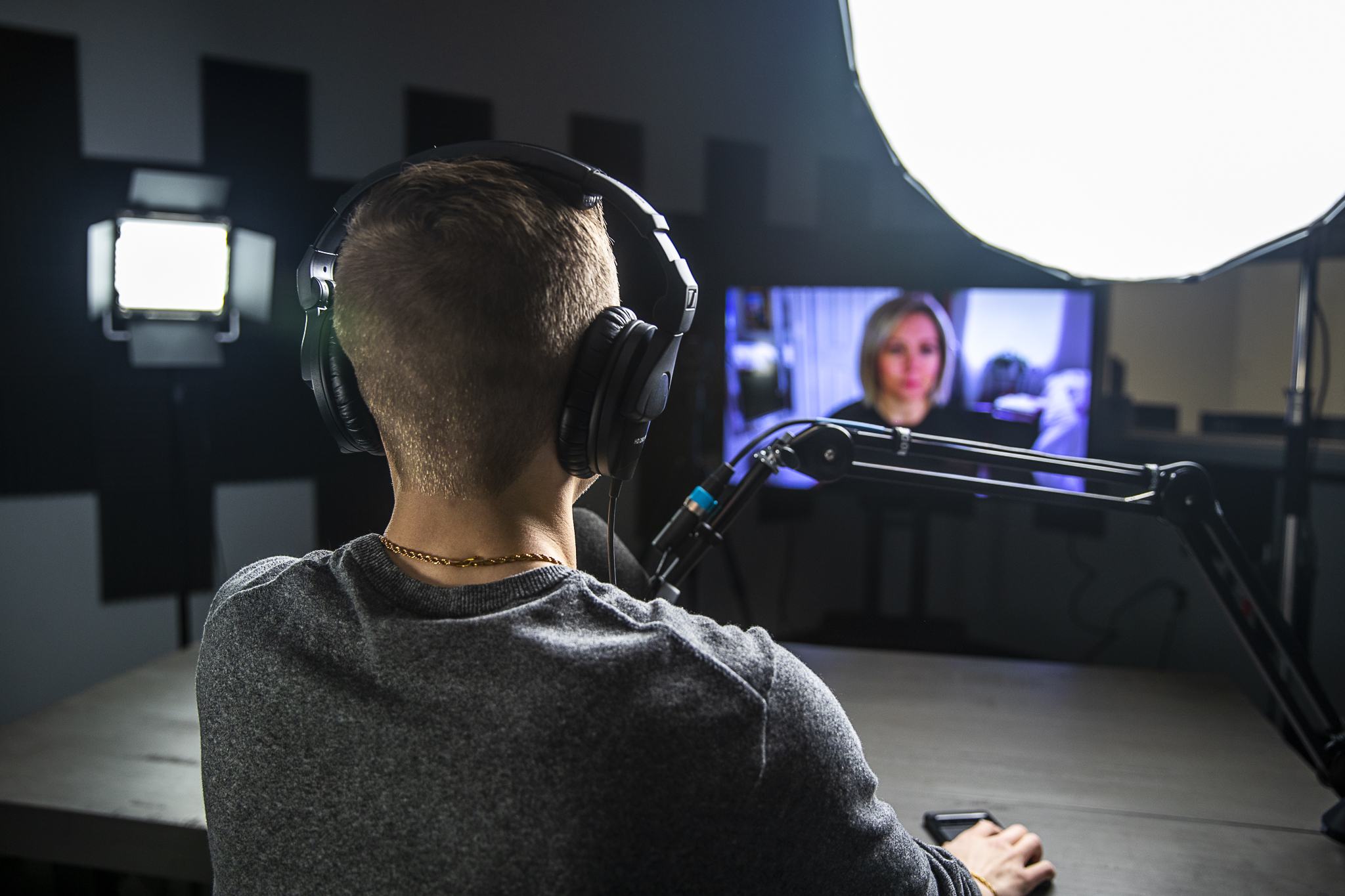 A man holding a video interview on his podcast.